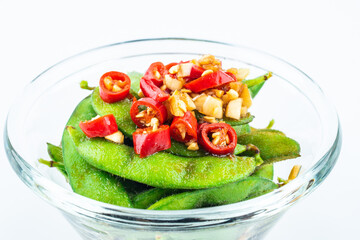 A plate of delicious cold edamame on white background