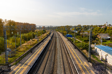 Fototapeta na wymiar Empty outdoor train station platform at sunday morning