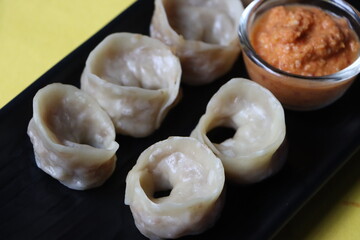 Dumpling or momos served with sauce 
