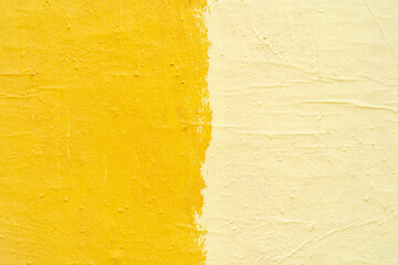 Yellow paint texture. Interior of a modern loft. Abstract bright background. The facade of an old house. Divided in half.