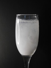 glass of water with white paint