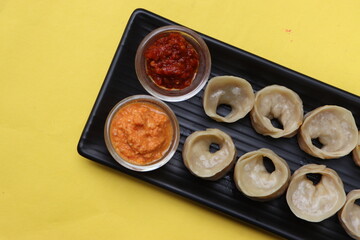 Dumpling or momos served with sauce 