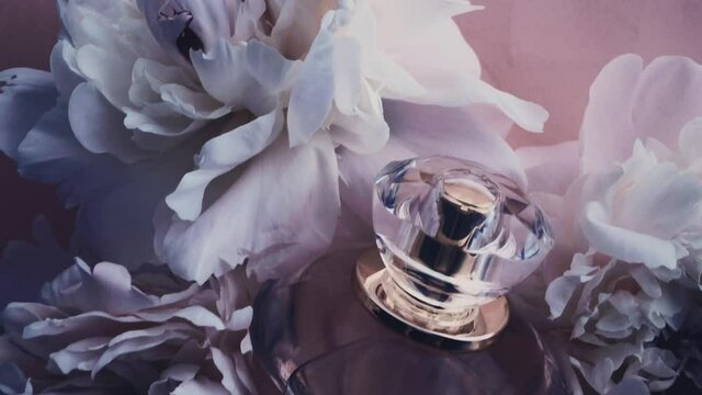 Purple perfume bottle with peony flowers, chic fragrance scent as luxury cosmetic, fashion and beauty product background, stock footage