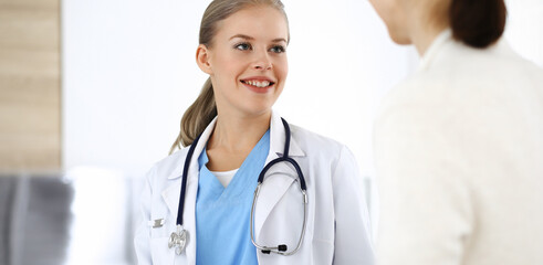 Woman - doctor consults her female patient in clinic. Medicine concept