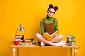 Full length photo of minded pensive girl sit table legs crossed write copybook look copyspace think...