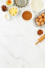 Baking background with ingredients standing on a marble table surface