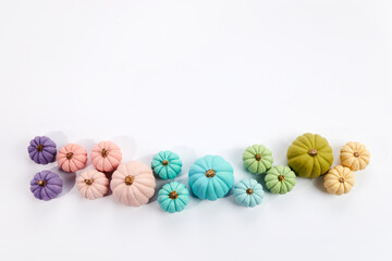 Rainbow pumkins on aqua colour background. Harvest thanksgiving halloween