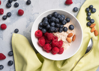 oatmeal in a plate with raspberries and blueberries and almonds