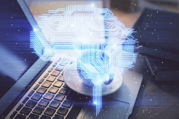 Double exposure of work space with computer and human brain drawing hologram. Brainstorm concept.