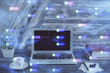 Double exposure of desktop computer and technology theme hologram. Concept of software development.