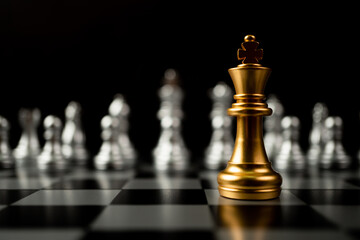 Golden King chess standing in front of other chess, Concept of a leader must have courage and...