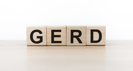 Word GERD Gastroesophageal reflux disease from cubes on the table