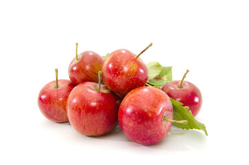 small red apples on a white background. Heap of ripe delicious apples. Autumn harvest.