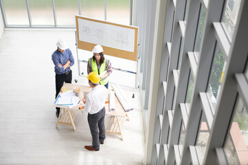Fototapeta premium Top view of engineering people are meeting , Engineering people, corporate working, teamwork concept.