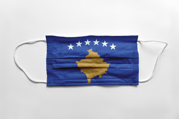 Face mask with Kosovo flag printed, on white background, isolated