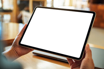 Mockup image of a woman holding digital tablet with blank white desktop screen