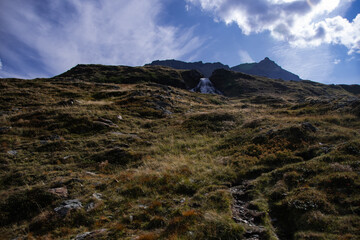 Small waterfall in the mountains with more spectacular sky