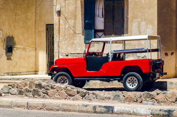 Red old car parked on the street, Dahab Egypt