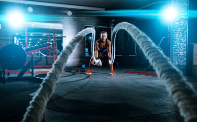 beautiful young black sportswoman in the gym. performs a workout.