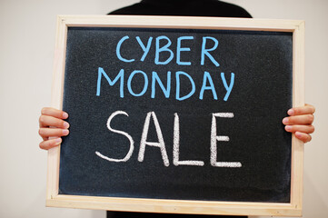 Cyber monday sale written on blackboard. Black friday concept. Boy hold board.