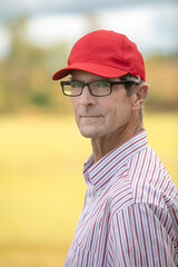 Attractive Senior White Male wearing Red Baseball Cap