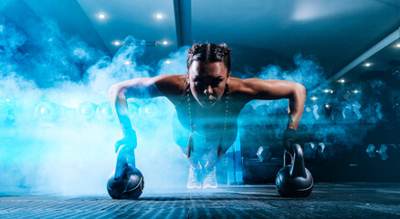 Obraz na płótnie Canvas beautiful young black sportswoman in the gym. performs a workout.