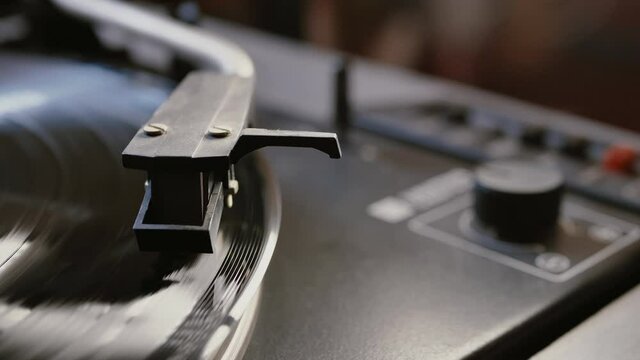 Cinemagraph vinyl record is spinning. Old retro turntable.turntable stylus on a record