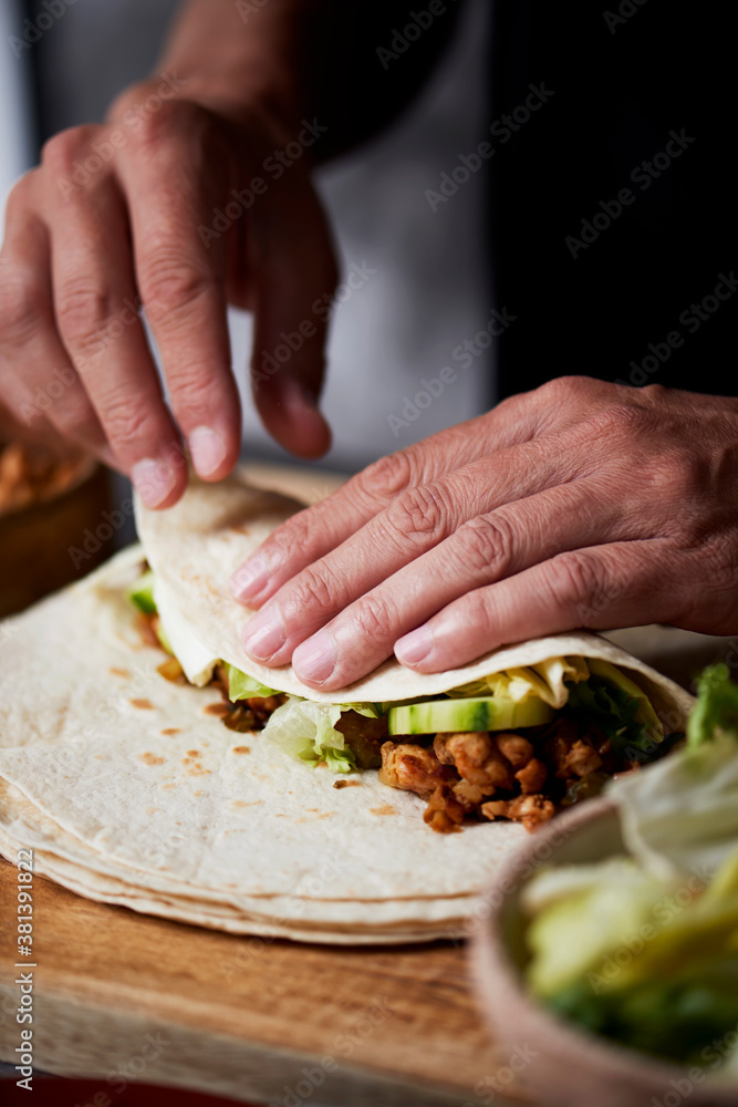 Poster man preparing a durum or a burrito