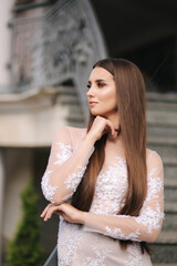 Close up portrait of beautiful young woman with evening makeup in white dress like bride