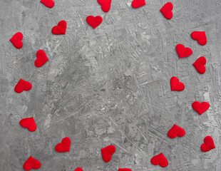 Romantic background with red hearts on concrete.