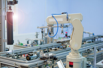 Industry 4.0 concept; artificial intelligence in smart factory prototype. The robot picks up the...
