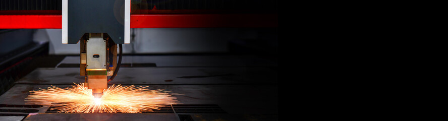 Raytools laser cut head machine while cutting the sheet metal with the sparking light in factory,...