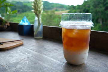 selective focus on a cup of cold brew coffee on the wooden table with blurred background