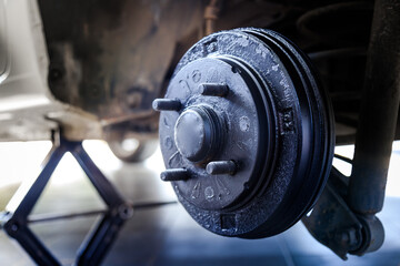A rear hub of the car after removing a tire and wheel, maintaining a brake and wheel system, car jack-up for change a car wheel, Close-up shot