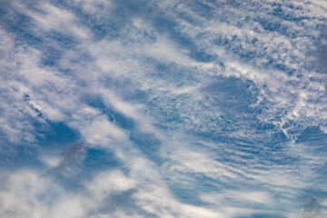 Fototapeta premium Fluffy clouds on a blue sky background. Dramatic skyes.