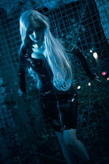 Gothic witch with amazing dark look in urban surroundings