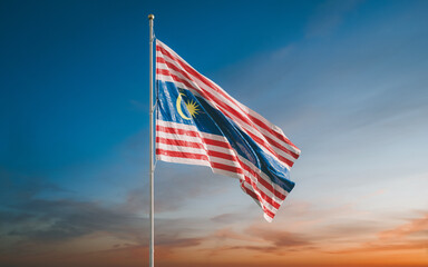 A beautiful Kuala Lumpur national flag fluttering in the wind against the backdrop of the sunset sky. A symbol of the capital of Malaysia. 