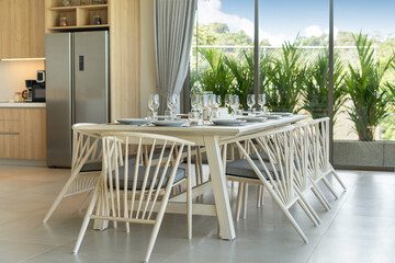 Interior design of dining area in luxury villa, apartment feature wooden dining table, bench and white dining chair