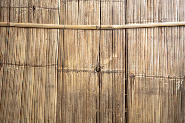 A floor mat made of bamboo strips which joined together by tying them or using nails, to form a sheet by tying them up or using nails to fasten them with traverse bamboo pieces.