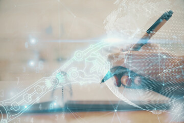 Fototapeta premium Tech theme hologram over woman's hands taking notes background. Concept of hightech. Double exposure