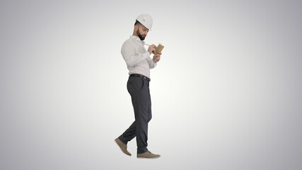 Fototapeta premium Confident mature man in formalwear and hardhat writing down note