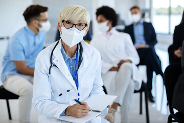 Female doctor attending healthcare seminar during COVID-19 pandemic.