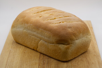 baked homemade bread on wooden chopping board