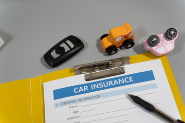 toy car, key, pen, document, car insurance concept on table