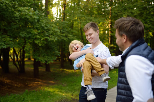 Handsome Middle Age Man And His Two Sons. Big Age Difference Between Siblings.