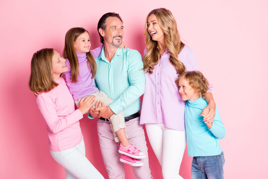 Photo of dream idyllic big family daddy hold younger daughter mommy laughing enjoy spend together weekend hold hand son isolated over pink color background