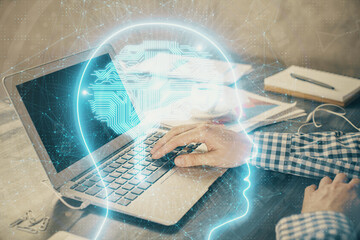 Man typing on keyboard background with brain hologram. Concept of big Data.