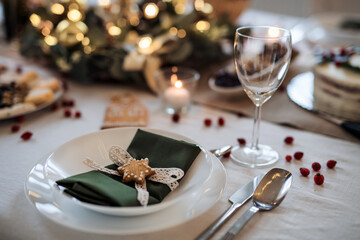 A close-up of plate on table set for dinner meal at Christmas time.