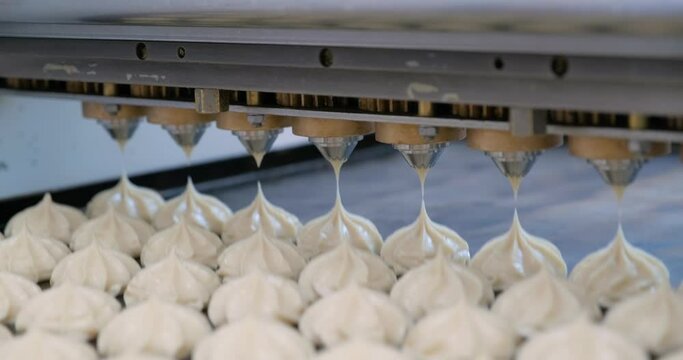 the process of depositing marshmallows or profiteroles on the jigging machine