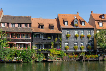 Fototapeta premium historic and colorful half-timbered houses on the banks of the Regnitz river in Bamberg in Bavaria